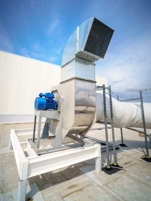 The air conditioning and ventilation system of a large industrial building is located on the roof. It consists of air ducts, air conditioning, smoke removal and ventilation