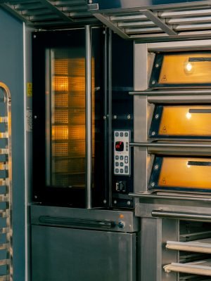 turned on preheated hot oven for baking large quantities of baked goods in a professional bakery kitchen