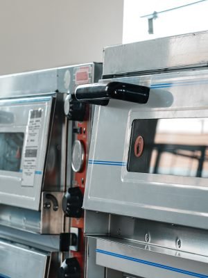 Two industrial pizza ovens in a shop close up